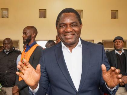 Zambia’s President Hakainde Hichilema shares a light moment with journalists after casting his vote at a polling station in Lusaka, Zambia, Thursday.