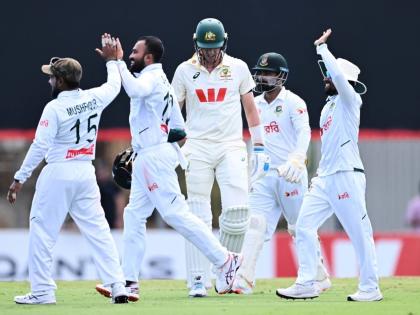 Pat Cummins (centre) of Australia walks from the field after being dismissed by Mehidy Hasan Miraz (second left) of Bangladesh during play on day four of the first cricket Test in Darwin, Australia, Sunday, August 16, 2026.  