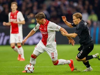 Ajax’s Mika Godts (left) duels for the ball with Besiktas’ Jonas Svensson during the Europa League  match between Ajax and Besiktas, at the Johan Cruyff Arena, in Amsterdam, Netherlands, on September 26, 2024. 