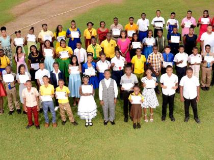 Award recipients pause for a group photograph during Discovery Bauxite’s annual PEP scholarship awards ceremony.