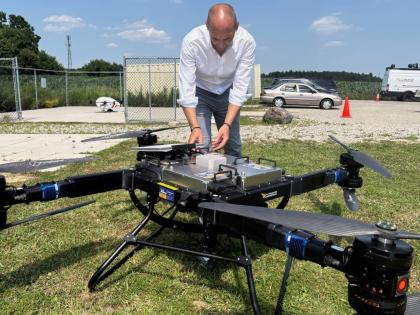 AP
Volatus Aerospace COO Greg Colacitti inspects a heavy-lift drone before a test run on July 13 in Kleinburg, Ontario, Canada.