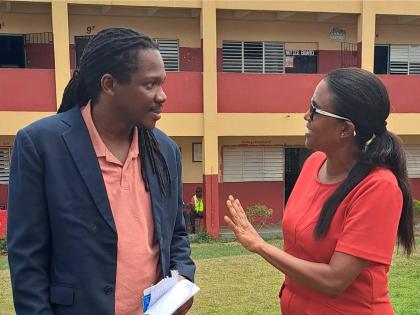 St Catherine North Western Member of Parliament Damion Crawford (left) in conversation with Trisha Williams-Singh, chairperson of the Early Childhood Commission, at the recently held certification fair.