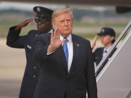 President Donald Trump waves after arriving off Air Force One, Friday, Aug. 28, 2026, at Joint Base Andrews, Md. (AP Photo/Mark Schiefelbein)