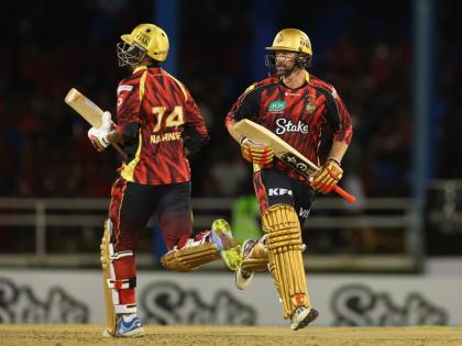 
Trinbago Knight Riders Sunil Narine (left) and Colin Munro go for a run during their Republic Bank Caribbean Premier League match against the Barbados Tridents at Queen’s Park Oval on Friday night.