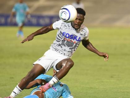 
Rajay Wright of Cavalier FC is brought down by a sliding tackle from Frank Salas of Sacedo FC during their Concacaf Caribbean Cup football match at the National Stadium on August 20.