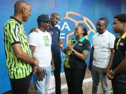 Tynielle Chambers-Barnett (third right), Group Business Development Manager, Cari-Med Group, Kirk FP Division engages with (from left) Keith Wellington, President, Inter-Secondary Schools Sports Association, Omar 'Rambo' Wedderburn, coach, St Elizabeth Tec