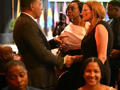 Prime Minister Dr Andrew Holness greets Minister of Health, Environment and Sustainability of the Cayman Islands, Katherine Ebanks-Wilks, during the opening ceremony for the 48th Regional Conference of the Commonwealth Parliamentary Association (CPA), Cari