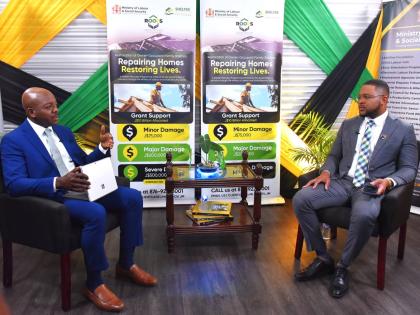 Labour and Social Security Minister, Pearnel Charles Jr. (left), making a point during a recent interview with Jamaica Information Service (JIS) Chief Executive Officer (CEO), Giovanni Dennis, at the Ministry’s North Street offices in St Andrew.