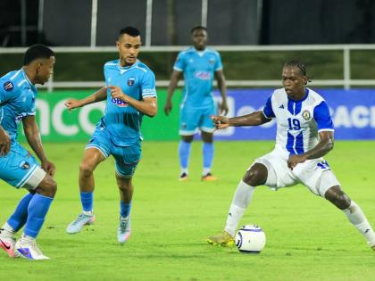 Mount Pleasant Football Academy’s Warner Brown (right) controls the ball as he faces three Salcedo FC opponents during the Caribbean Club Championship football match in the Dominican Republic on Wednesday. The game ended 1-1.