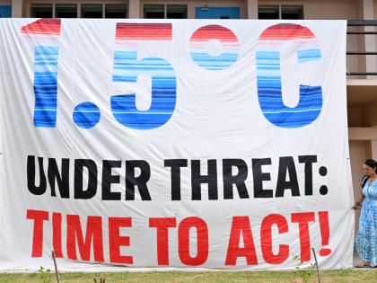 A climate change banner is unfurled by Greenpeace during the Pacific Islands Forum Leaders Meeting in Koror, Palau.
