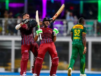 The Antigua and Barbuda Falcons batsmen celebrate their team's victory over the Jamaica Kingsmen at the end of the Caribbean Premier League final at Kensington Oval in Barbados on Sunday night. - CPL photo