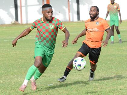 Humble Lion’s Suejay Graham (left) ries to get away from Tivoli Gardens’ Ajuma Johnson during their Jamaica Premier League match at the Edward Seaga Sports Complex  on September 13.