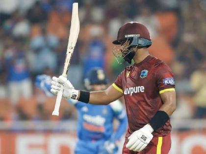 
West Indies batter Shai Hope raises his bat after scoring a century during the third One-Day International against India at the PCA New Cricket Stadium in Tira yesterday. Hope ended unbeaten on 162. 