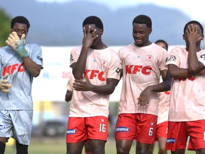 Mona High School players celebrate a Walker Cup victory over Vauxhall High after a 2-1 win in their quarterfinal match at the Drewsland Stadium in Kingston on Saturday.