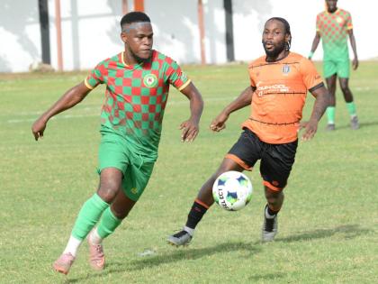 Suejay Graham (left) of Humble Lion and  Ajuma Johnson of Tivoli Gardens battle for the ball during their Jamaica Premier League match at the Edward Seaga Sports Complex on Sunday, September 13, 2026.