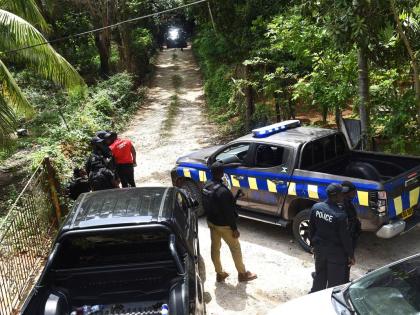 
Members of the Jamaica Constabulary Force (JCF), are seen in the Five Miles area of Sligoville in St Catherine where three of their colleagues were shot and three gunmen killed in an operation.