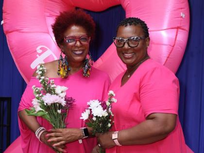 President of the Jamaica Reach to Recovery (JR2R), Sandra Samuels (left), greets breast cancer survivor, Diana Walters-Heron, as they flaunt their bouquets during a floral arrangement session at the JR2R’s monthly meeting in partnership with Sygnus.