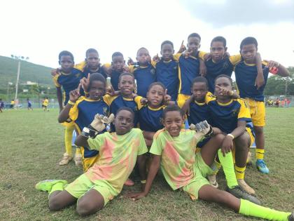 Balmagiee Primary players celebrate winning the Youth Football League (YFL) Junior Cup Kingston and St Andrew Regional Championship at the University of the West Indies, Mona Bowl on Saturday.