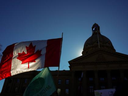A Canadian flag flies in front of the of the Alberta Legislature during a pro-Canada rally in Edmonton, Alberta, Canada, Sunday.