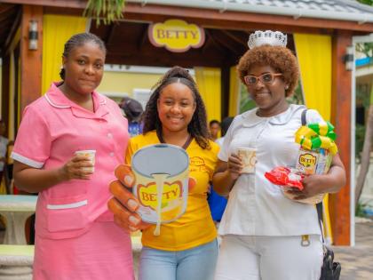 From left: Trishauna Davis, patient care assistant; Deidra Grey, brand manager - Betty; and Margaret Robb, nurse administrator, share a moment during Betty’s Porridge Month breakfast pop-up at the Kingston Public Hospital on Friday, October 9. As a gestu