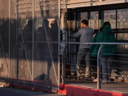 A group of undocumented migrants is deported by US Immigration and Customs Enforcement agents across the McAllen–Hidalgo–Reynosa International Bridge in McAllen, Texas, March 13.