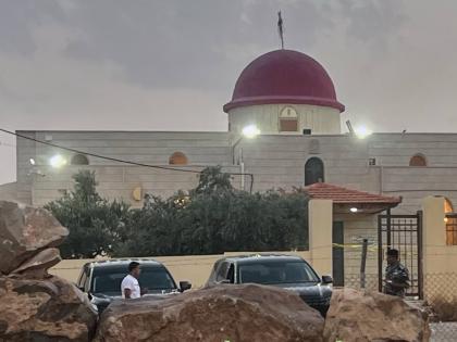 A security officer stands guard a Greek Orthodox Church where gunmen opened fire during a funeral earlier in Hamoud village, in Jordan's Karak governorate, Friday, Oct. 23, 2026. (AP Photo)
