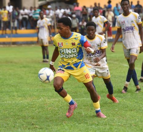St Elizabeth Technical High School (STETHS) skipper, Deandre Barnett (left), moves away from Munro College’s Silence Manyaka during their ISSA daCosta Cup Zone E game at the STETHS Sports Complex in September.