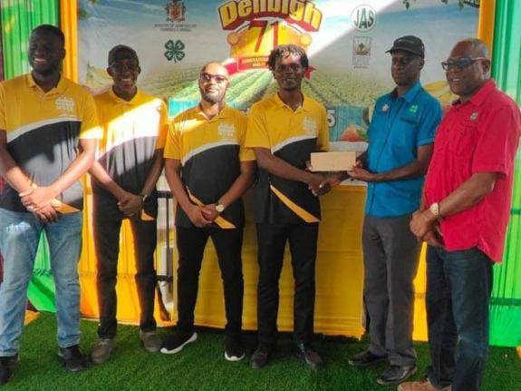 Developers of the ‘AgriConnect’ mobile application accept their $40,000 cash prize from Chairman of the National Youth in Agriculture Committee, Joseph Small (right), and Director of Field Services at the Jamaica 4-H Clubs, Garfield Ewart (second right