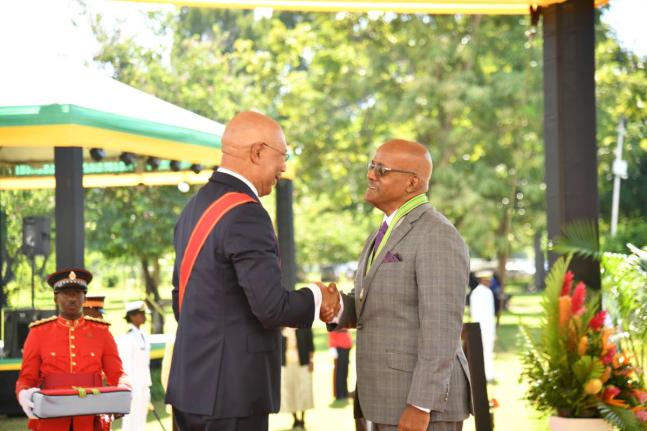 Justice Kissock Laing (right) receiving his membership in the Order of Distinction in the rank of Commander from Governor General Sir Patrick Allen. 