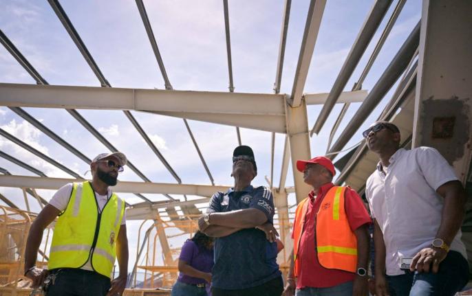 Minister of Local Government and Community Development,  Desmond McKenzie (second left), with Mayor of Black River Richard Solomon (left), along with other key stakeholders. survey the extensive damage to the Black River Market in St.Elizabeth, following t