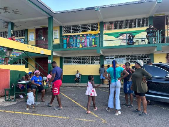People are seen in Petersfield High School, Westmoreland which was converted as a hurricane shelter.
