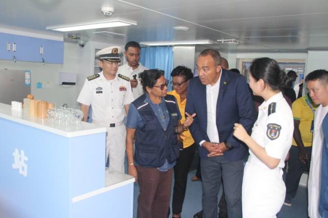 At left Dr Jacquiline Bisasor-McKenzie, chief medical officer, speaks with Dr Christopher Tufton (centre), minister of health and wellness, and crewmembers of the Ark Silk Road, a Chinese Navy hospital. 