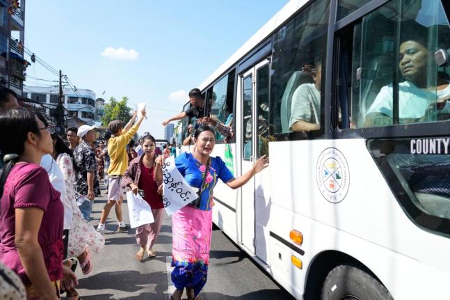 Released prisoners, in a bus, are welcomed by family members and colleagues after they left Insein Prison in Yangon, Myanmar. 