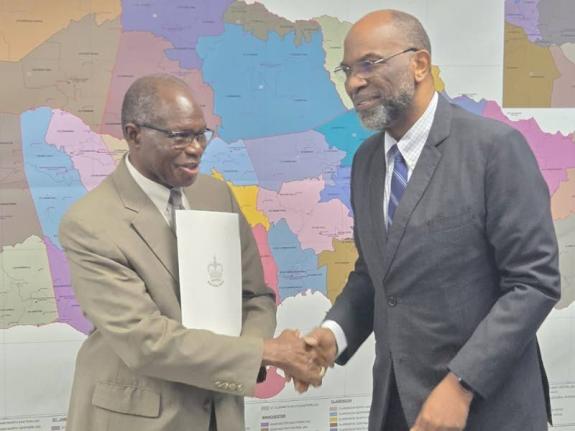 Jamaica Labour Party Member of Parliament Everald Warmington (left), receives his instrument of appointment from Chairman of the Electoral Commission of Jamaica (ECJ), Earl Jarrett.