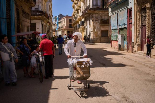 A baker selling baked goods in the streets of Havana, Cuba.