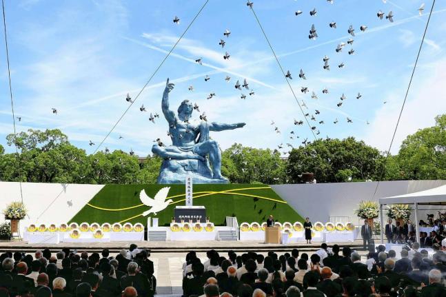 Doves fly over the Peace Statue during a ceremony to mark the 79th anniversary of the US atomic bombing at the Peace Park in Nagasaki, southern Japan August 9, 2024. 
