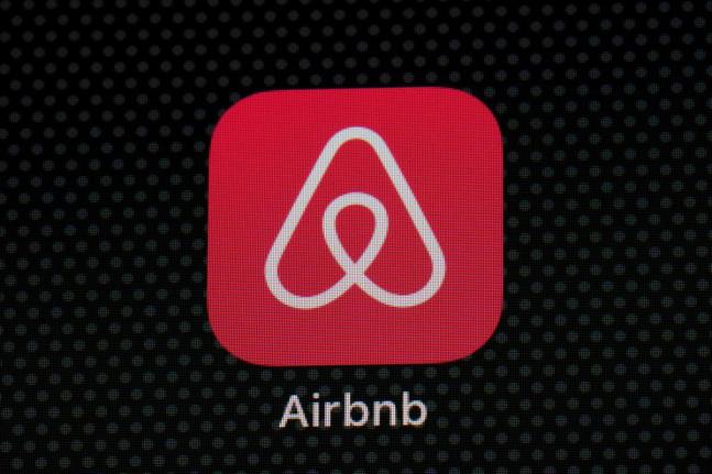 The Airbnb app icon is displayed on an iPad screen.