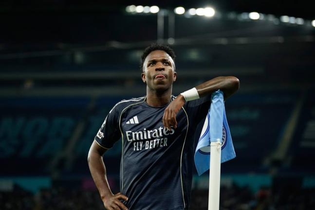 Real Madrid’s scorer Vinicius Junior reacts at the corner flag after scoring the opening goal from the penalty spot during the Champions League round-of-16 second-leg football match against Manchester City in Manchester, yesterday.