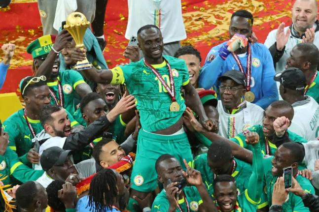 Senegal's Sadio Mane holds the trophy aloft as he celebrates with teammates after winning the Africa Cup of Nations final football match between Senegal and Morocco in Rabat, Morocco, Sunday, January 18, 2026. (AP Photo/Youssef Loulidi, File)