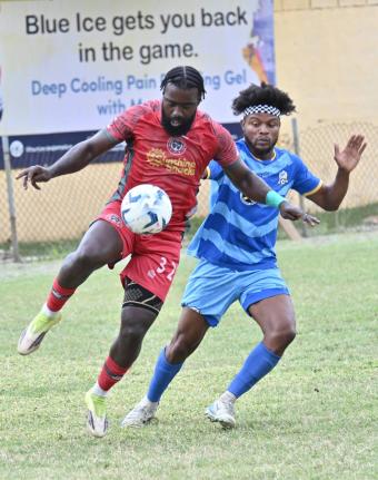 Montego Bay United’s Kimani Arbouine (left) controls the ball ahead of Molynes United’s Enrique Gordon in a Jamaica Premier League encounter at the Constant Spring Sports Complex yesterday. The game ended 1-1.