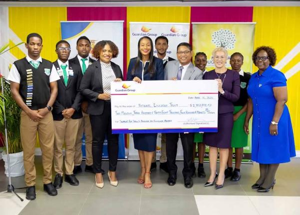 Students of Frome Technical High School and their principal look on as (from left) Executive Director of the National Education Trust, Latoya Harris-Ghartey; State Minister in the Ministry of Education, Skills, Youth and Information, Rhoda Moy Crawford; Gu