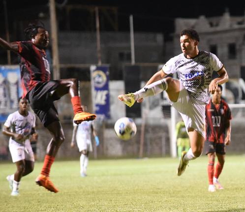 Ricardo Thomas (second left) of Arnett Gardens  and Shad San Millan (second right) of Cavalier  compete for the ball during their Jamaica Premier League football match at Anthony Spaulding Sports Complex on Thursday. Arnett Gardens won 2-1.