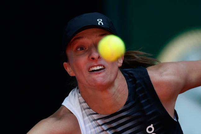 Iga Swiatek of Poland returns the ball to Ann Li of the US during the Madrid Open tennis tournament in Madrid yesterday.