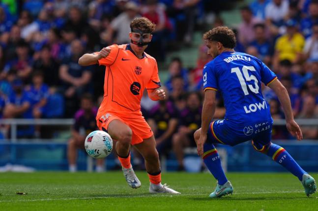 
Barcelona’s Fermin Lopez (left) and Getafe’s Sebastian Boselli compete for the ball during the Spanish La Liga football match in Getafe, Spain, yesterday.