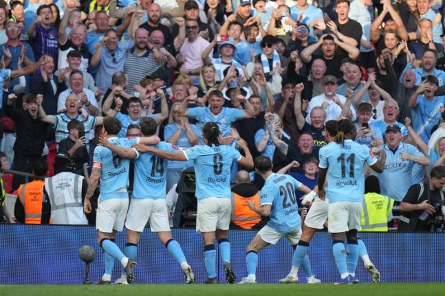 
Manchester City players celebrate after scoring during the FA Cup semi-final football match against Southampton in Manchester, England, yesterday.