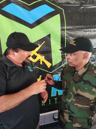 Christopher Samuda (right), president, Jamaica Olympic Association (JOA), listens intently as Dr Jason McKay outlines plans for the McKay Security St Mary FA Major League at the competition’s launch and opening games on Sunday at the Westmoreland Oval in