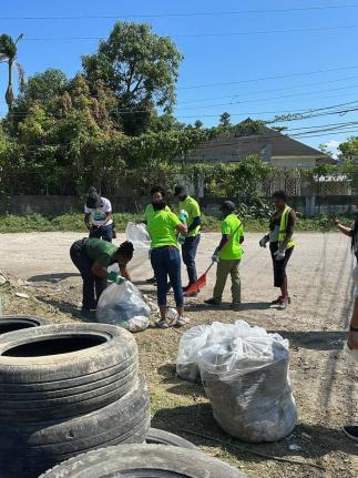 Community members join in on the National Solid Waste Management Authority (NSWMA) Earth Day clean-up initiative in Hoist Brissett, Hanover,  on Wednesday, April 22.