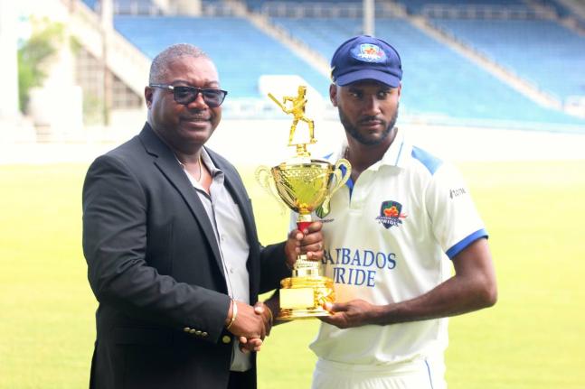 Barbados Pride captain Kragg Brathwaite (right) collects the bilateral series trophy from Jamaica Cricket Association CEO Courtney Francis at the end of the West Indies Championship match against Jamaica Scorpions at Sabina Park on Tuesday.