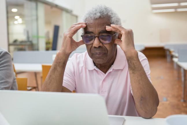Representational image of a senior citizen having difficulties with technology