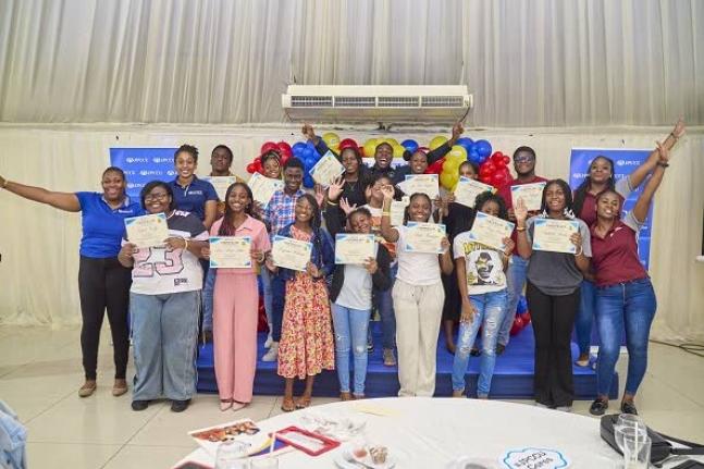 Participants of the Jamaica Police Co-operative Credit Union Limited’s (JPCCU) 2026 Smart Savers Expo celebrate after receiving their certificates alongside JPCCU team members and guest speaker, ASP Romario Reid, following the event at the Terra Nova Hot